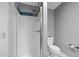 This bathroom features a shower with blue mosaic tile detailing and a white toilet at 3518 Travis Ct, Chapel Hill, NC 27516