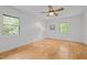 The bedroom offers two windows, hardwood floors, a ceiling fan, and ample natural light at 3518 Travis Ct, Chapel Hill, NC 27516
