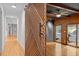 Stylish sliding barn door leading to a cozy bedroom with hardwood floors at 3518 Travis Ct, Chapel Hill, NC 27516