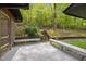 Expansive deck overlooking a lush backyard with terraced landscaping and a play area beyond at 3518 Travis Ct, Chapel Hill, NC 27516