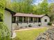 Charming home featuring a brick pathway, white painted brick, a covered porch and professional landscaping at 3518 Travis Ct, Chapel Hill, NC 27516