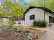 Home exterior view showing a brick pathway, painted brick, black trimmed windows and verdant landscaping at 3518 Travis Ct, Chapel Hill, NC 27516