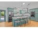 Gourmet kitchen boasts stainless steel appliances and a center island with bar seating at 3518 Travis Ct, Chapel Hill, NC 27516