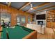 Game room featuring a stone fireplace and a pool table next to a comfortable seating area at 3518 Travis Ct, Chapel Hill, NC 27516