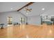 Bright living room featuring hardwood floors, vaulted ceiling with wood beam and screened in porch access at 3518 Travis Ct, Chapel Hill, NC 27516