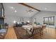 Living room with hardwood floors, fireplace, vaulted ceiling with wood beam and comfortable seating at 3518 Travis Ct, Chapel Hill, NC 27516
