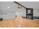 Spacious living room with hardwood floors, brick fireplace, vaulted ceiling with wood beam and open layout at 3518 Travis Ct, Chapel Hill, NC 27516