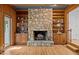 Living room featuring a stone fireplace and built-in shelving, perfect for entertaining at 3518 Travis Ct, Chapel Hill, NC 27516