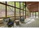 Screened-in porch featuring comfortable wicker seating and ceiling fans, perfect for enjoying nature at 3518 Travis Ct, Chapel Hill, NC 27516