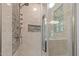 A glass-enclosed shower features a mosaic tile backsplash and an adjustable shower head at 3518 Travis Ct, Chapel Hill, NC 27516