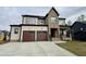 Charming home showcases a two-car garage, brick accents, inviting covered porch, and concrete driveway at 3601 Amelia Grace Dr # 18, Fuquay Varina, NC 27526