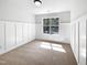 Bedroom with modern wainscoting and a large window offering ample natural light at 3638 Pine Needles Dr, Wake Forest, NC 27587