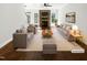 Bright living room with fireplace, hardwood floors, stylish sofas and a ceiling fan at 3638 Pine Needles Dr, Wake Forest, NC 27587