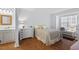 Serene bedroom showcasing neutral tones, wood floors, and a window for natural light at 3805 Chimney Ridge Pl # 003, Durham, NC 27713