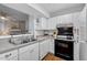 Functional kitchen with white cabinetry, modern appliances, and an open view to the living area at 3805 Chimney Ridge Pl # 003, Durham, NC 27713