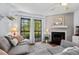 Cozy living room with a fireplace, plush seating, and a balcony offering outdoor views at 3805 Chimney Ridge Pl # 003, Durham, NC 27713