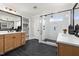A bathroom featuring a glass shower, dual sinks, and dark tile flooring at 382 Belmont Stakes Ln, Wendell, NC 27591