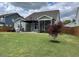 Large backyard featuring a covered patio, lush lawn, and fenced perimeter for privacy at 4118 Rillcrest Grove Way, Fuquay Varina, NC 27526