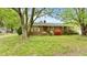 Charming brick home with mature trees, flowering shrubs, and a welcoming front entrance at 428 Mitchell Ave, Franklinton, NC 27525