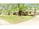Charming brick home with mature trees, flowering shrubs, and a welcoming front entrance at 428 Mitchell Ave, Franklinton, NC 27525