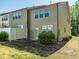 Townhome's backyard showcasing a small grassy area, privacy fence, and access to the back of the property at 4901 Rose Quartz Way, Raleigh, NC 27610