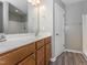Bathroom featuring double sinks, wood cabinets, and a large mirror at 4901 Rose Quartz Way, Raleigh, NC 27610