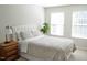 Bright bedroom featuring large windows, a comfortable bed, and a calming, neutral color scheme, creating a serene atmosphere at 4901 Rose Quartz Way, Raleigh, NC 27610