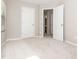 A tidy, carpeted bedroom featuring neutral walls, two doors, and natural light, with electrical outlets on the wall at 4901 Rose Quartz Way, Raleigh, NC 27610
