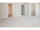 Empty bedroom featuring neutral walls, carpeted floors and doors to bedroom closets at 4901 Rose Quartz Way, Raleigh, NC 27610