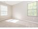 A clean, empty bedroom with neutral walls, carpet flooring, and natural light streaming through the blinds at 4901 Rose Quartz Way, Raleigh, NC 27610
