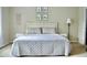 Bedroom with a neatly made bed, wall art and a night stand with lamp at 4901 Rose Quartz Way, Raleigh, NC 27610
