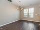 Light-filled dining room features hardwood floors and chandelier at 4901 Rose Quartz Way, Raleigh, NC 27610