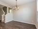 Dining room with hardwood floors, chandelier and stairs to the second floor at 4901 Rose Quartz Way, Raleigh, NC 27610