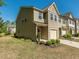 Side view of townhome showing the yard and concrete driveway and neighboring townhomes at 4901 Rose Quartz Way, Raleigh, NC 27610