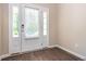 Foyer featuring a front door with sidelights, wood-look floors and white trim at 4901 Rose Quartz Way, Raleigh, NC 27610