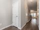 Hallway with wood-look flooring, white trim and access to other rooms at 4901 Rose Quartz Way, Raleigh, NC 27610