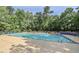 A community pool surrounded by trees offers residents a relaxing, fun outdoor space for recreation and socializing at 4901 Rose Quartz Way, Raleigh, NC 27610