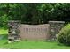 Stone sign marking the entrance to Fieldstone Crossing, set amongst a lush green lawn and mature trees at 4901 Rose Quartz Way, Raleigh, NC 27610