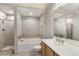Bright bathroom with tile flooring, a shower with glass door, and a soaking tub for relaxing at 501 Finsbury Street # 103, Durham, NC 27703