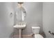 Neat half-bathroom with pedestal sink and toilet offer convenience for guests and complements the home's design at 501 Finsbury Street # 103, Durham, NC 27703