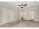 Spacious bedroom with neutral carpet, features a ceiling fan and multiple closets for ample storage at 501 Finsbury Street # 103, Durham, NC 27703