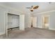 Spacious bedroom with a ceiling fan and multiple closet options for optimal storage solutions at 501 Finsbury Street # 103, Durham, NC 27703