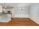 Inviting dining area with hardwood floors, chandelier lighting, and wainscoting, connecting to the kitchen at 501 Finsbury Street # 103, Durham, NC 27703