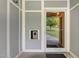 Building entryway features a secure entry system and a glass door view of the landscaped exterior at 501 Finsbury Street # 103, Durham, NC 27703