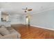 Inviting living area with hardwood floors, ceiling fan and comfortable seating, flowing into dining and kitchen spaces at 501 Finsbury Street # 103, Durham, NC 27703