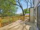 Backyard featuring a wooden deck overlooking landscaped yard and lush greenery at 511 Circle Dr, Burlington, NC 27215