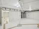 Clean basement with bright white walls and ceiling pipes at 511 Circle Dr, Burlington, NC 27215