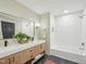 Bathroom featuring double sinks, modern fixtures, and sleek black tile flooring at 511 Circle Dr, Burlington, NC 27215
