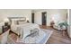 Comfortable bedroom with a plush bed, decorative pillows, a sitting area, and hardwood flooring at 511 Circle Dr, Burlington, NC 27215