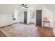 Bright bedroom featuring a ceiling fan, hardwood floors, and a cozy window seat at 511 Circle Dr, Burlington, NC 27215